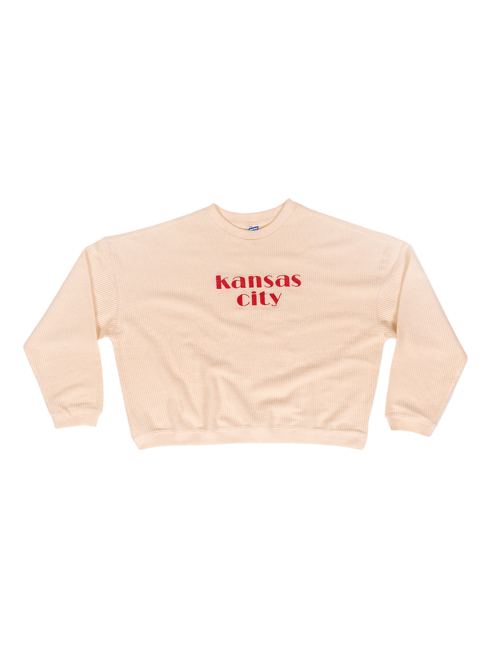 ivory sweatshirt with 'Kansas City' embroidered red text in center