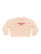 ivory sweatshirt with 'Kansas City' embroidered red text in center